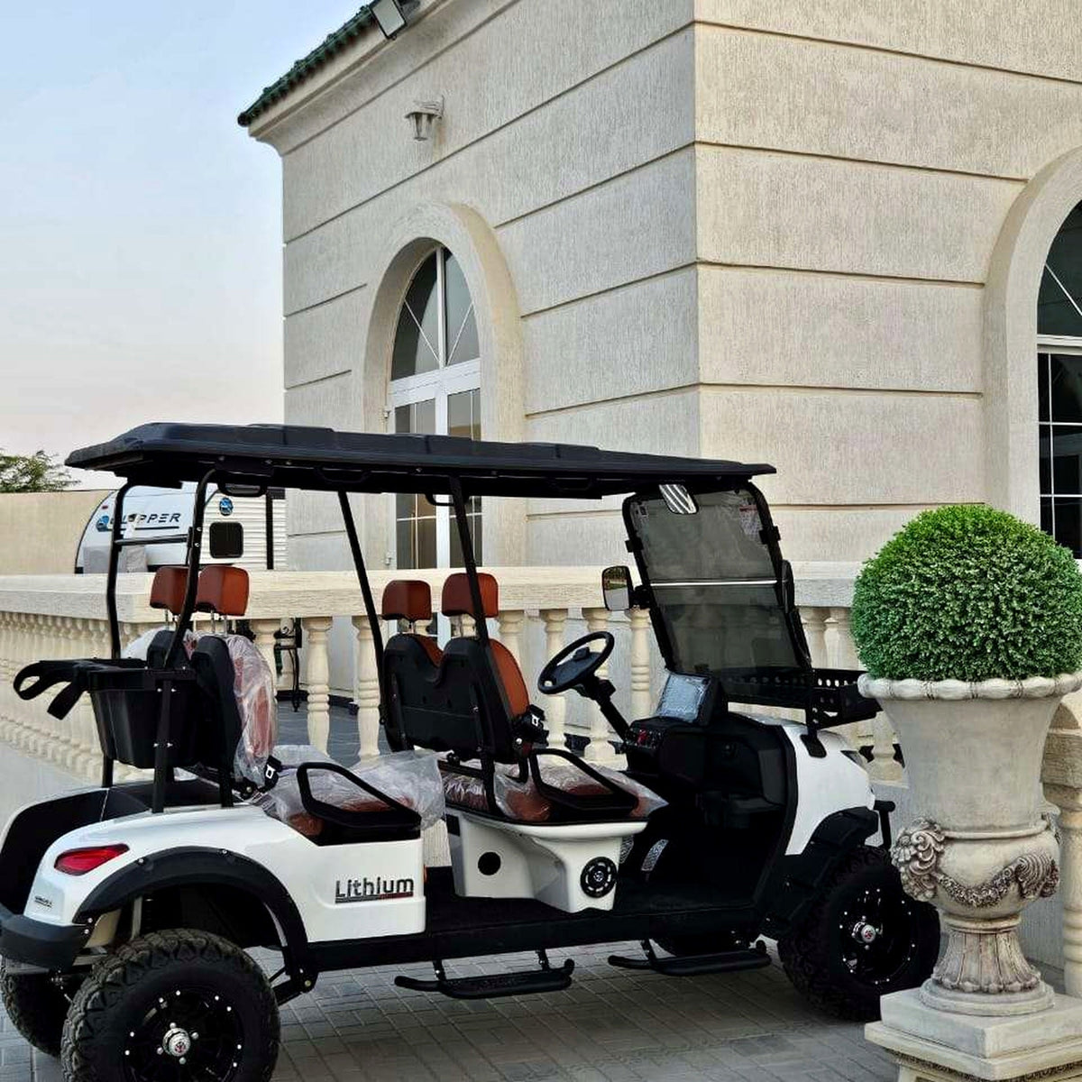 MXV Voyager 4 Trail lifted passenger cart in a courtyard